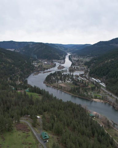Aerial view of Idaho river town nestled in forested mountains