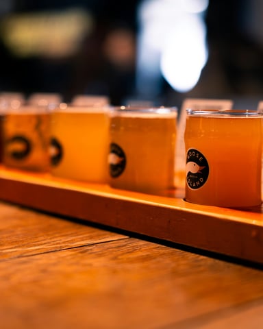 Craft beer flight on a wooden tray at a local brewery