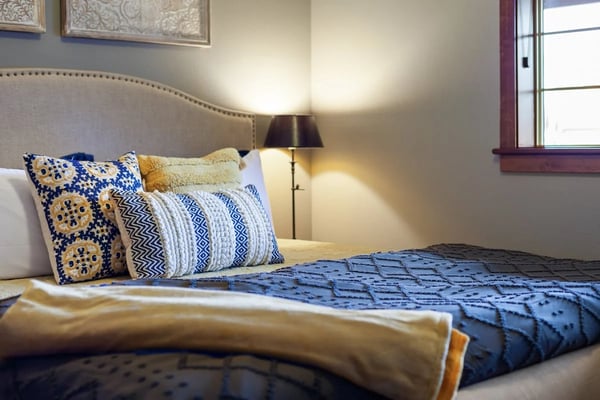Bright bedroom with carefully made bed