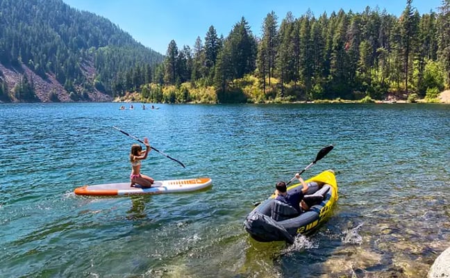 Crystal-clear waters of Lake Coeur d'Alene with forested mountain shoreline in North Idaho