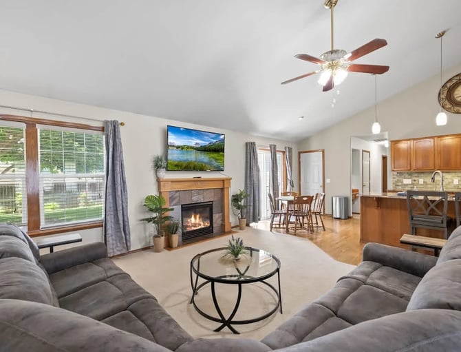 Interior of a furnished rental property showing kitchen and living amenities